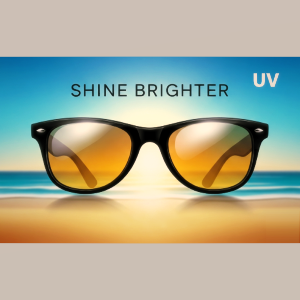 A pair of Voyager UV-Pro Sunglasses resting on a wooden beach deck with the ocean and a sunset in the background.